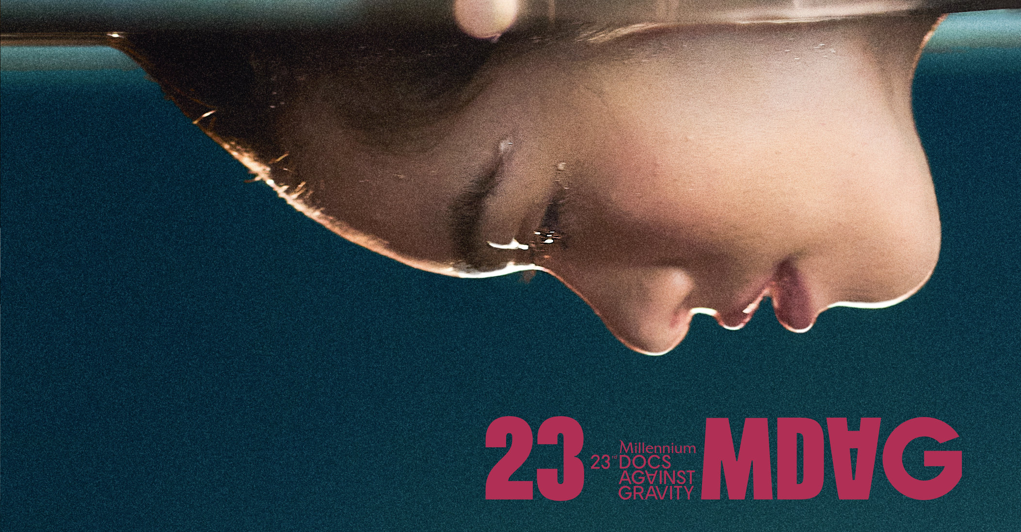 Głowa młodej kobiety zanurzona do połowy w wodzie.